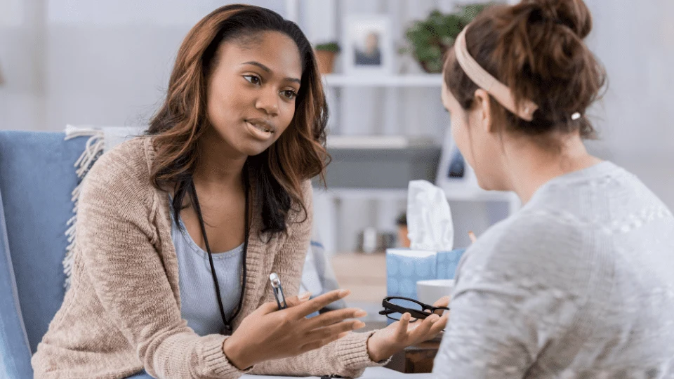 Young female counselor talks with client