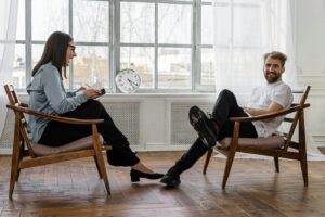 Counselor Sitting on Brown Wooden Chair