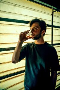 a man drinking from a glass