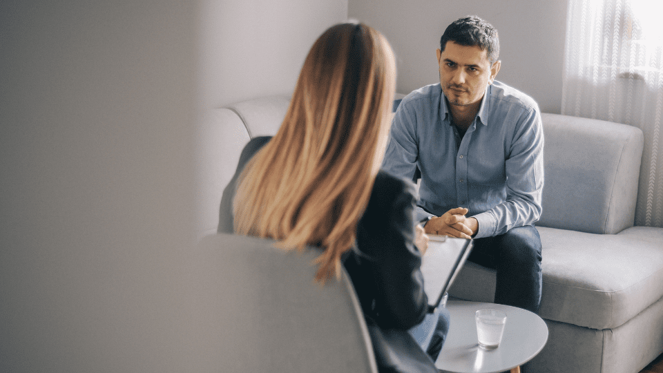 Mid age man having on on one counselling meeting