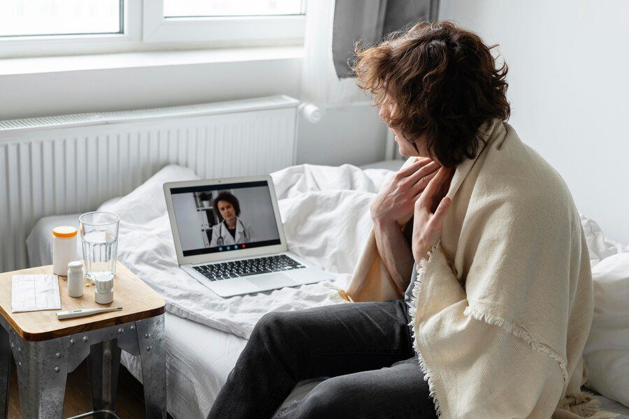 sick man having video call with doctor