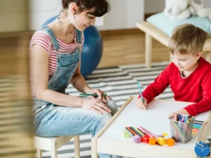 A mom sits on the floor with her son while he draws. This image is for the ADHD Treatment page. Our ADHD therapy and ADHD counselors serve Raleigh, Car, Mooresville, Holly Springs, and Wake Forest.