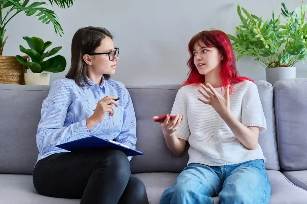 Therapist providing mental health support to adolescent