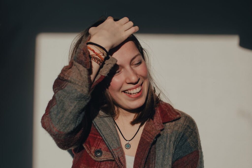 a-smiling-woman-holding-her-hair