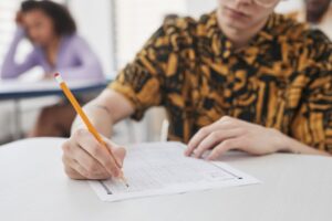 a-person-holding-a-pencil