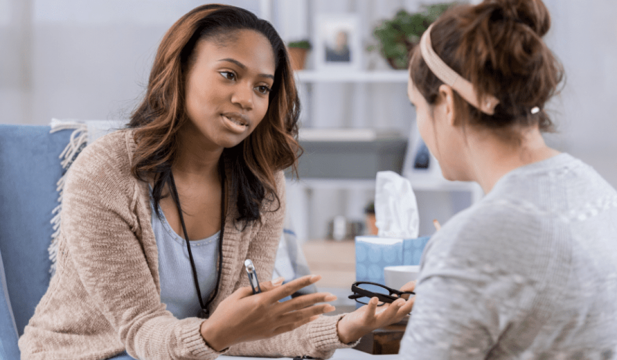 Young female counselor talks with client
